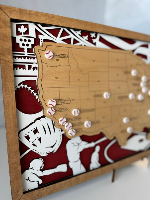 A framed wooden baseball map of the American West, featuring a light wood map of Colorado, Utah, and Nevada, decorated with baseball pins and set against a red and white baseball-themed background.